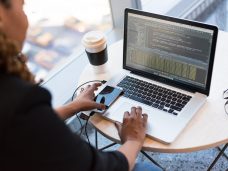 black-and-silver-laptop-computer-on-round-brown-wooden-table-1181243