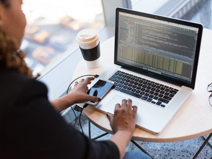 black-and-silver-laptop-computer-on-round-brown-wooden-table-1181243