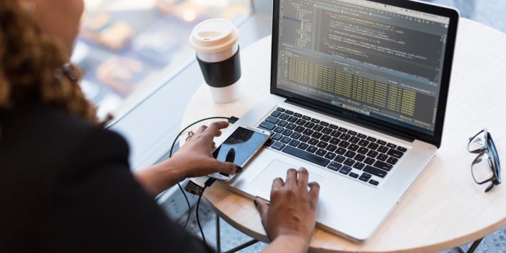 black-and-silver-laptop-computer-on-round-brown-wooden-table-1181243