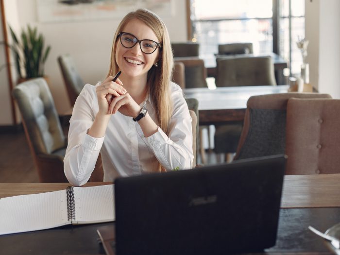 cheerful-young-businesswoman-in-eyeglasses-during-remote-3874619