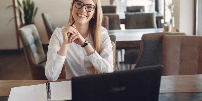 cheerful-young-businesswoman-in-eyeglasses-during-remote-3874619